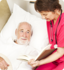 elderly man in bed with a nurse