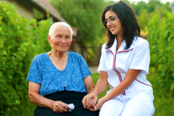 caregiver accompanying an elderly woman
